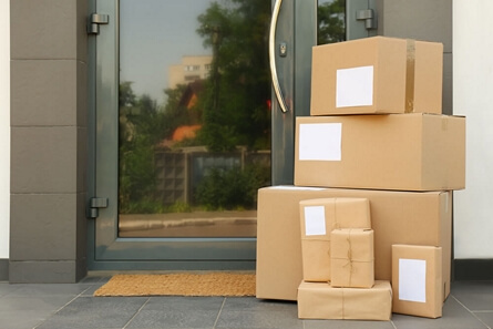 Stack of boxes delivered and left outside a front door